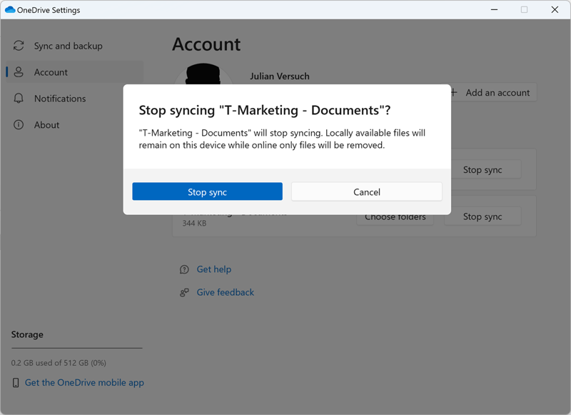 This screenshot shows the warning message, after you select Stop sync. The message says: “Stop syncing T-Marketing -Documents? T-Marketing Documents will stop syncing. Locally available files will remain on this device while online only files will be removed.”